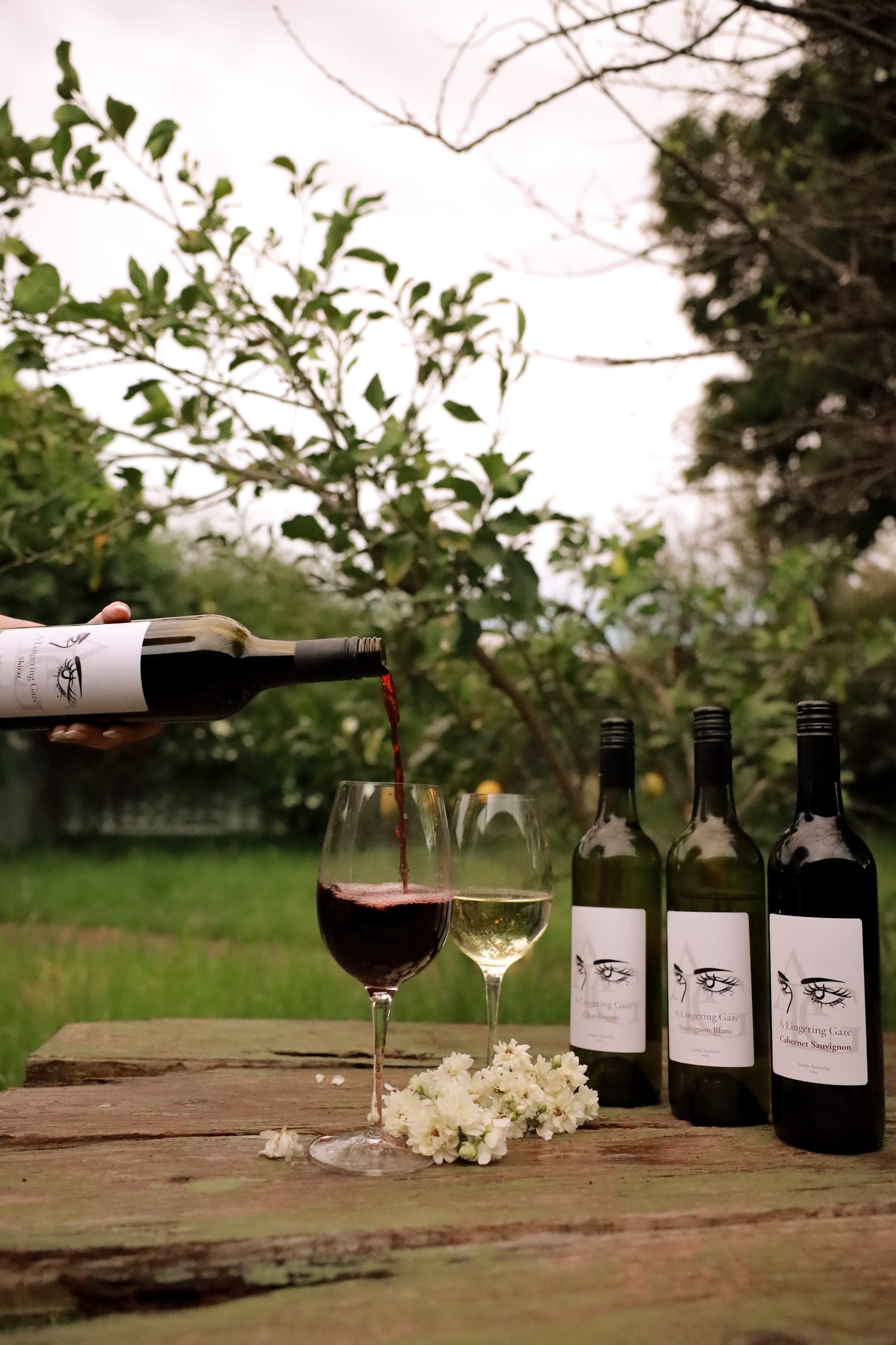 A Lingering Gaze Shiraz being poured beside the range on a garden table