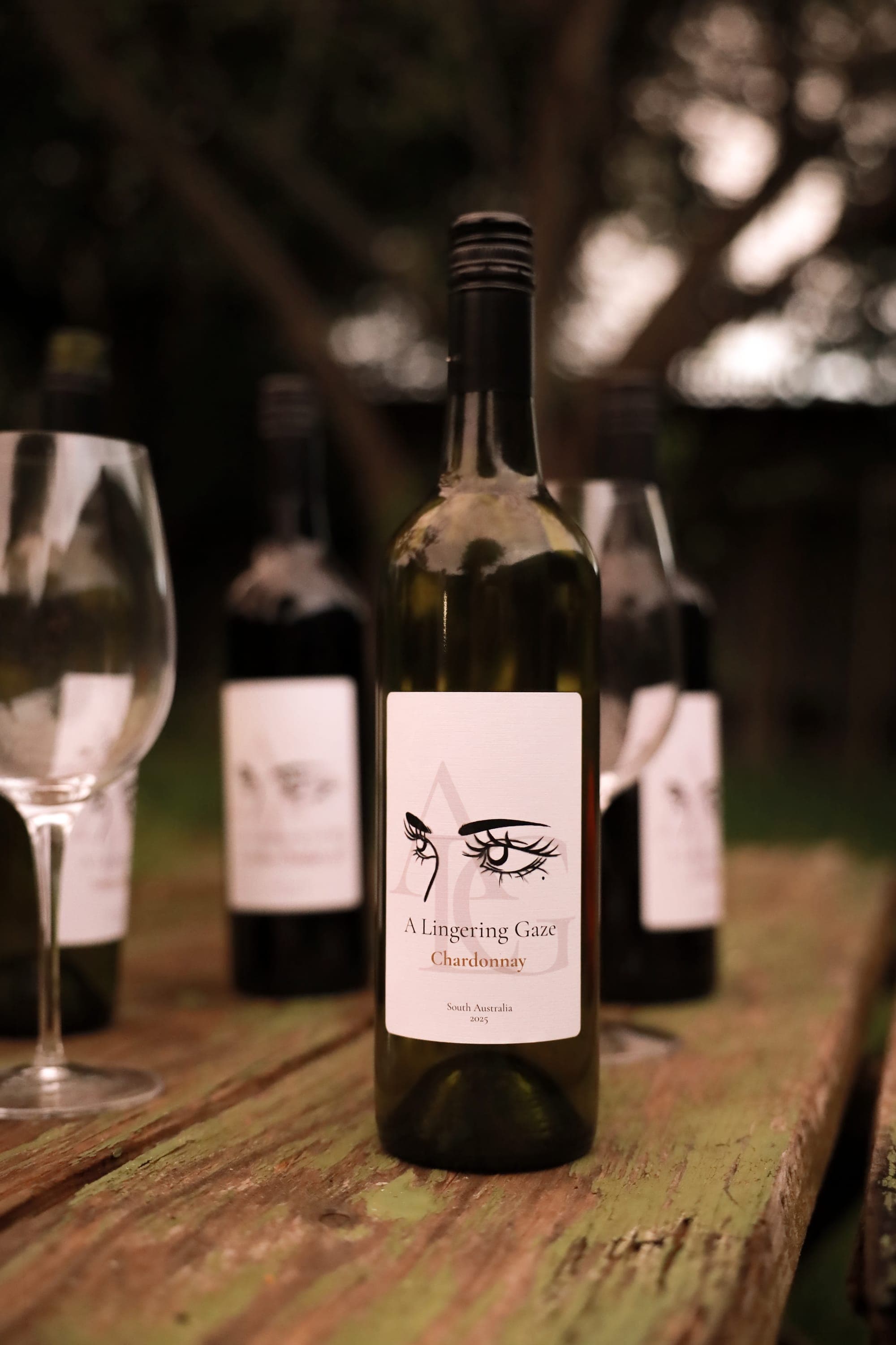 A Lingering Gaze Chardonnay on a weathered wooden table